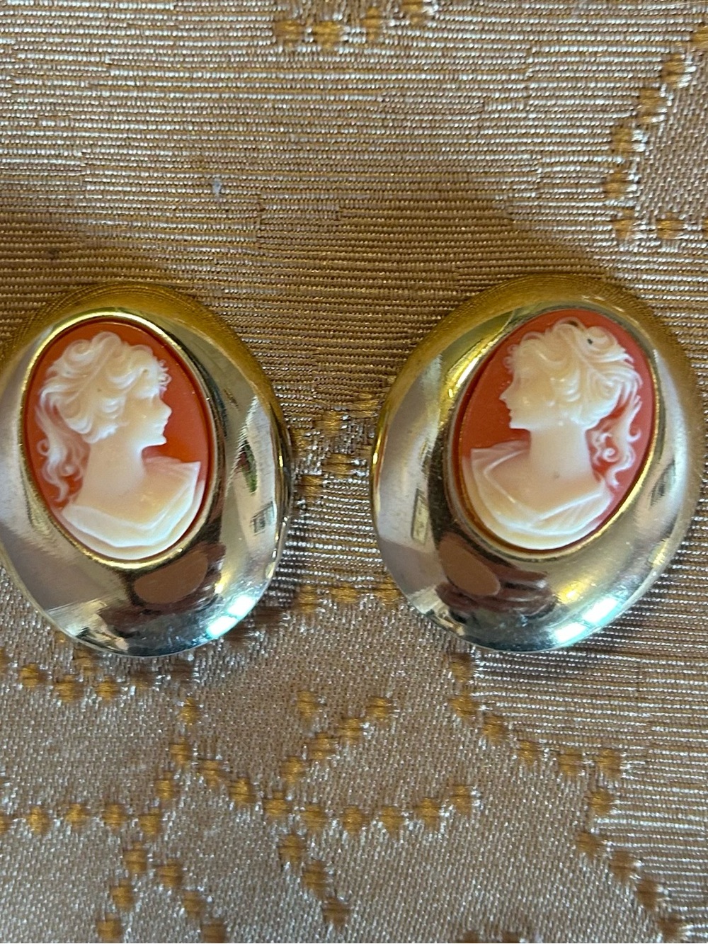 A pair of 1980s gold-tone and resin cameo clip-on earrings.